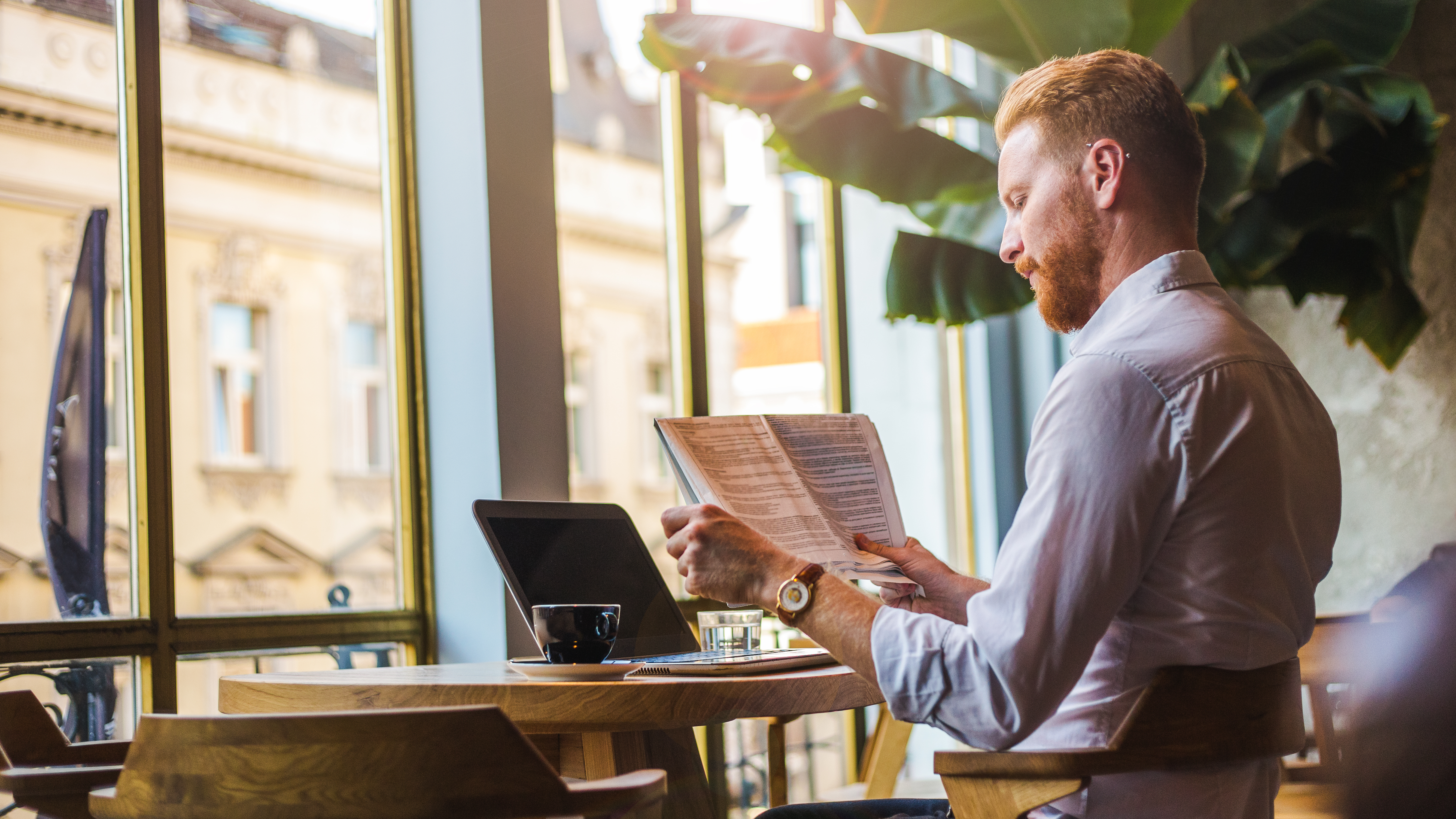 business person reading in a cafe
